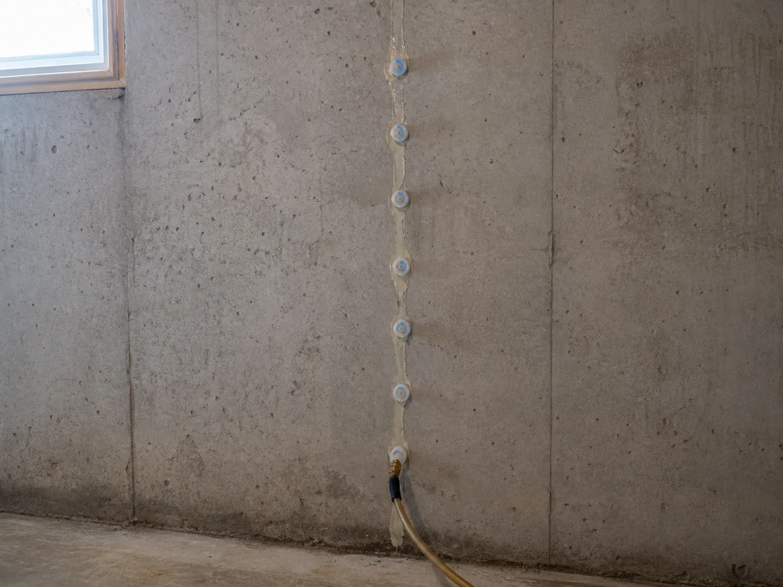 Polyurethane injection sealing a foundation crack
